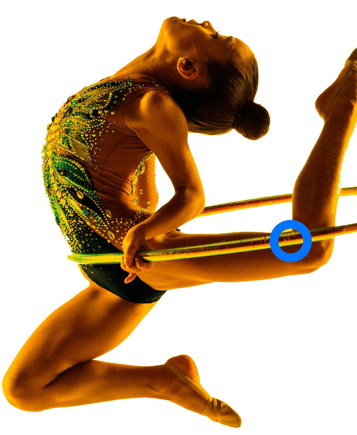 In the picture, a female gymnast executes a ring routine. She is bending her legs and looking up.